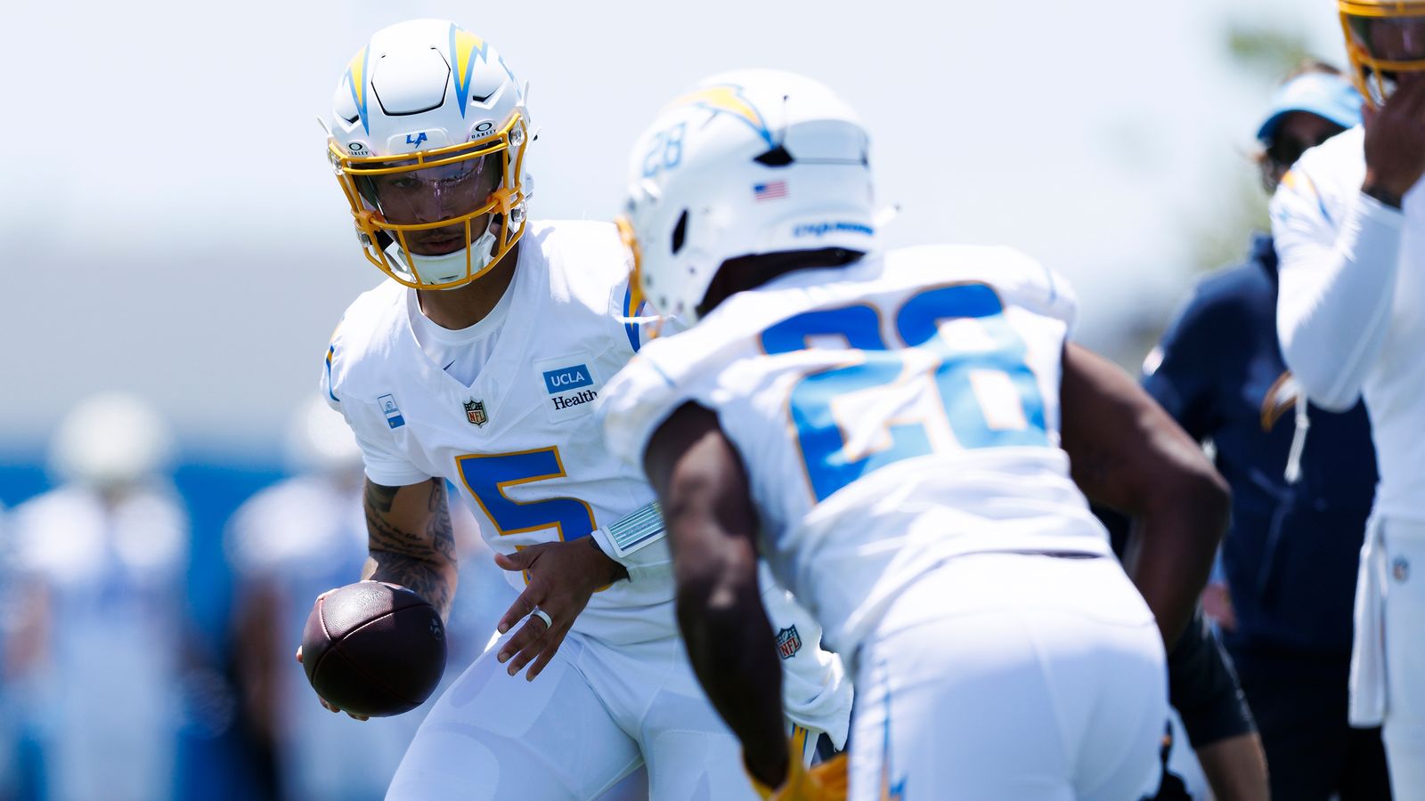 Trey Lance hands off to Kimani Vidal during Chargers OTA at The Bolt.