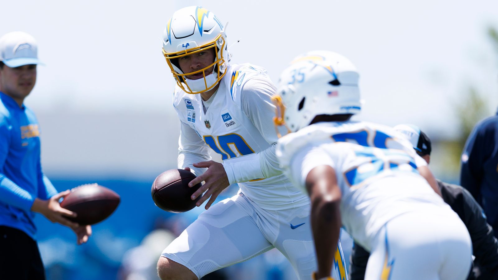 Justin Herbert hands off to Amar Johnson during Chargers OTA.