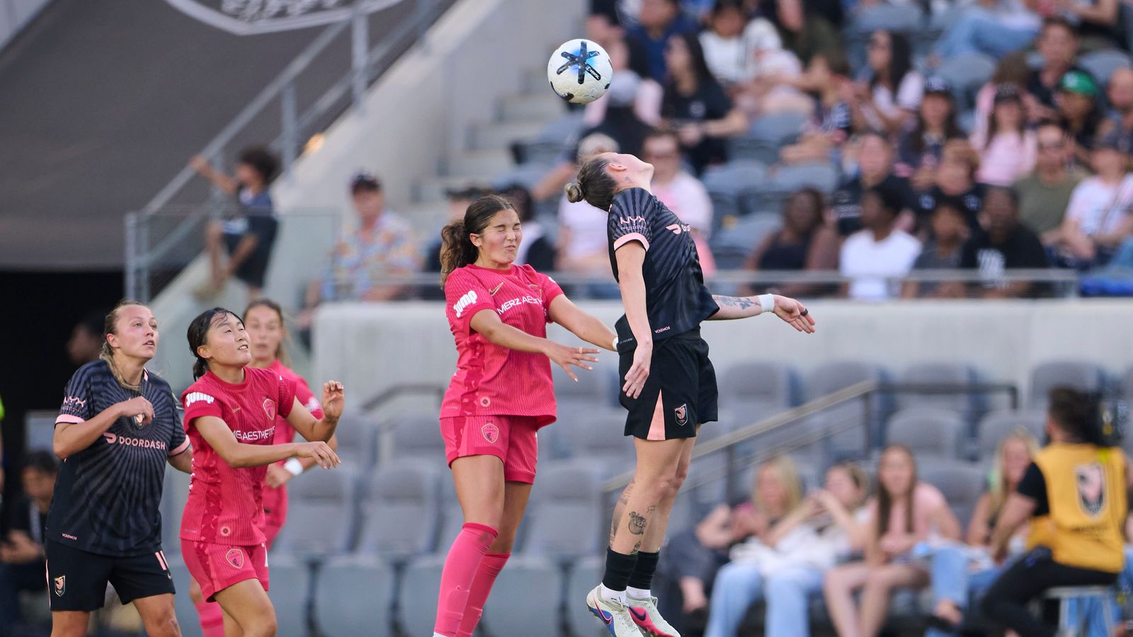 Maiara Niehues #12 leaps for the ball in NWSL match