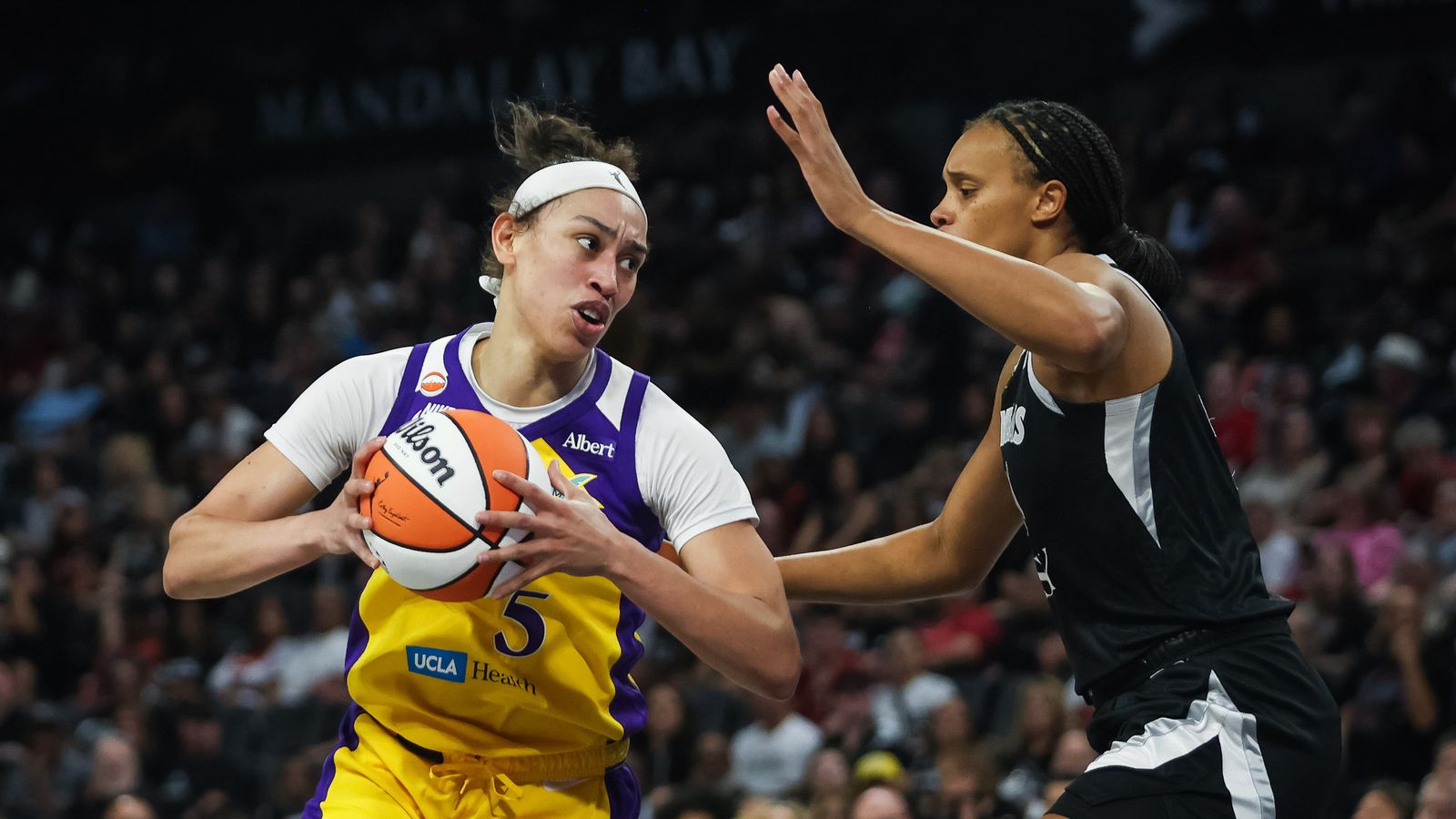 Dearica Hamby executes a post move against Brianna Turner in WNBA action.