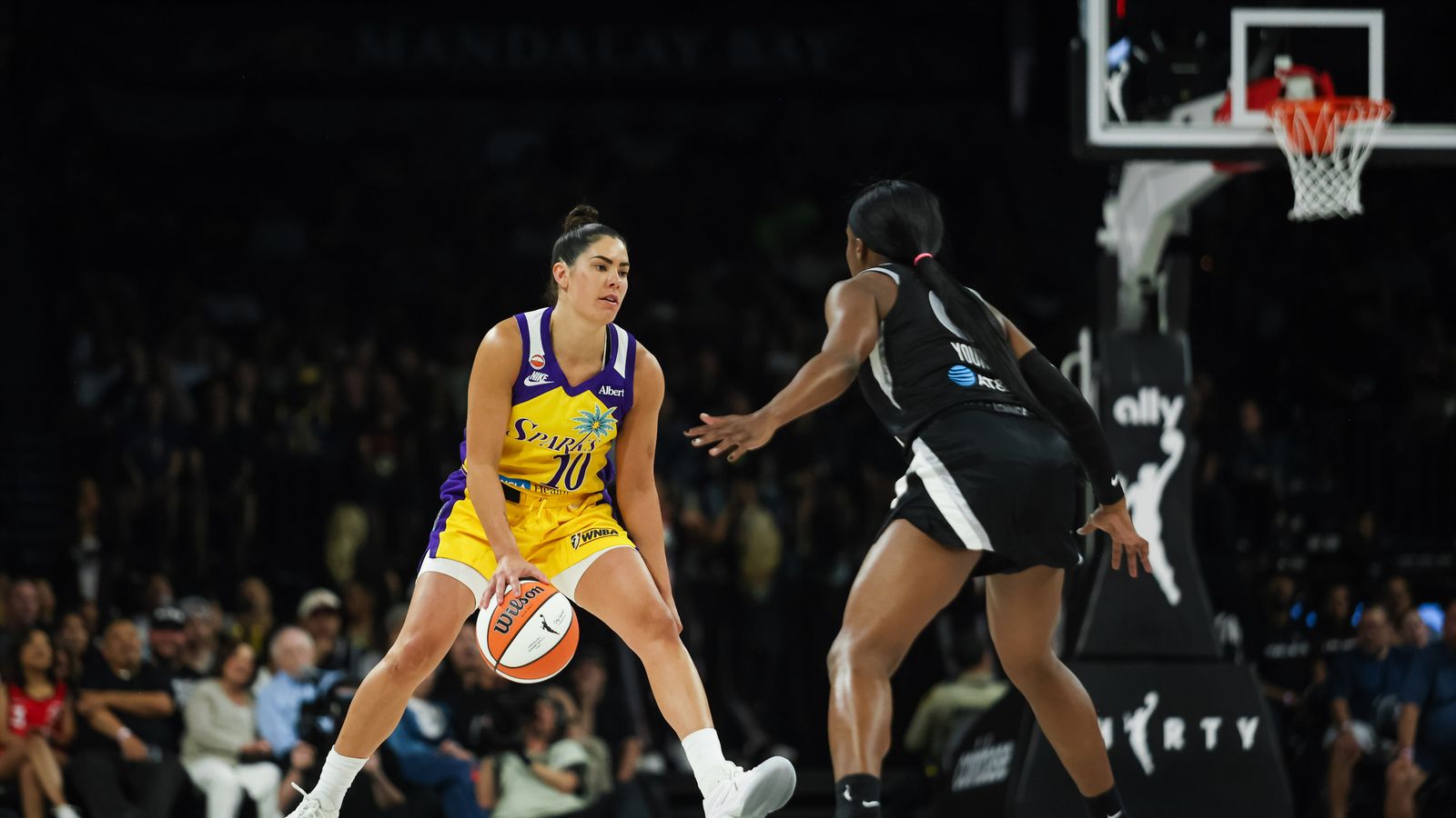 Kelsey Plum advances the ball in a game against the Aces.