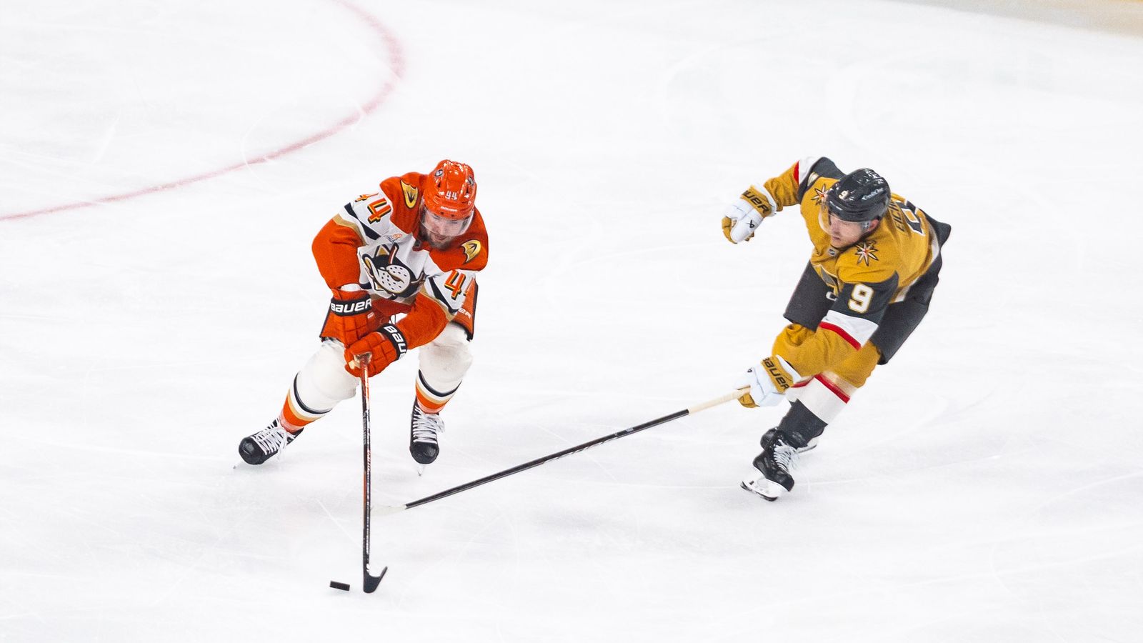 Ross Johnston advances the puck against Jack Eichel in NHL playoffs