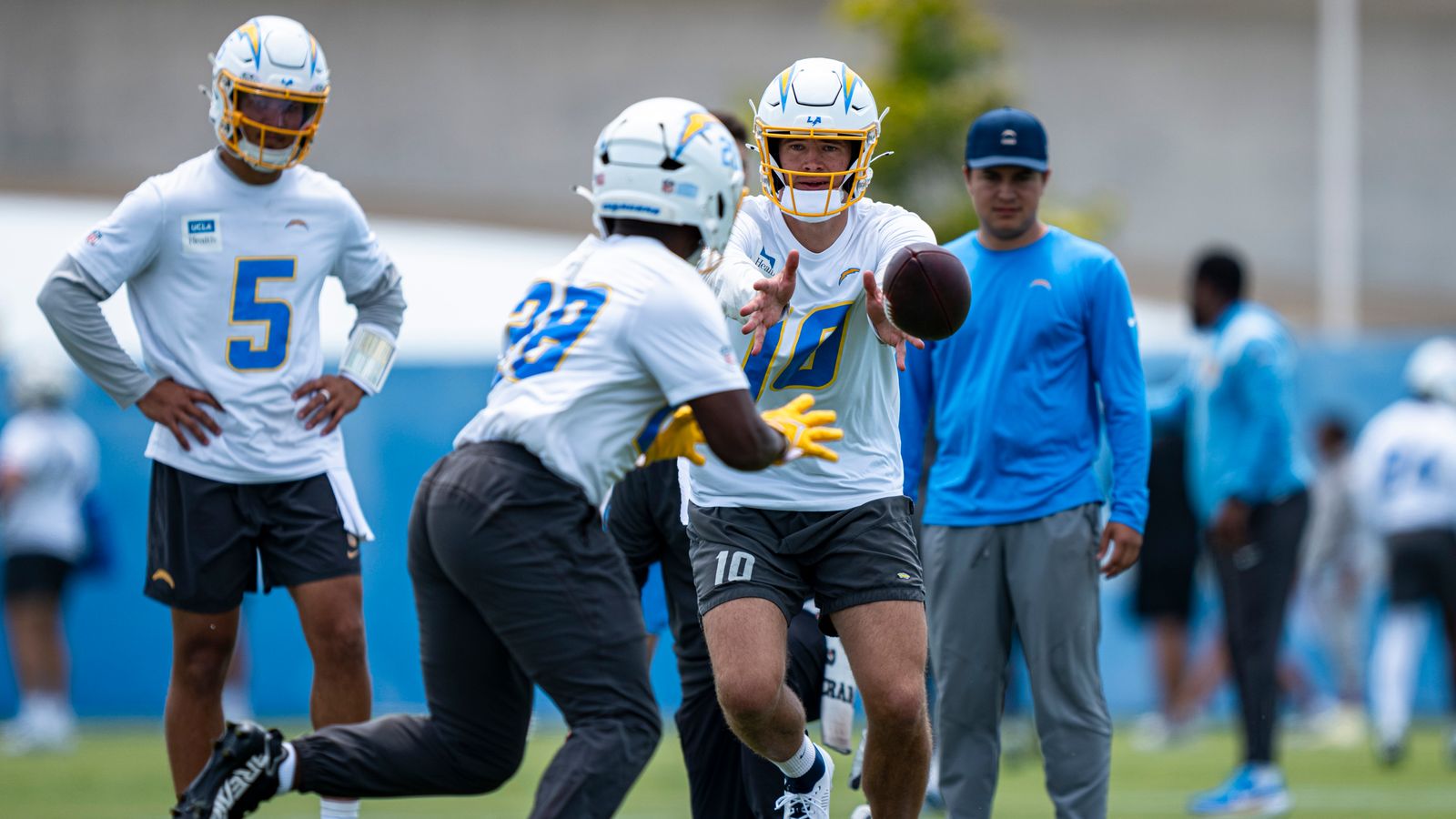 Justin Herbert passes to Kimani Vidal during Chargers OTA at The Bolt