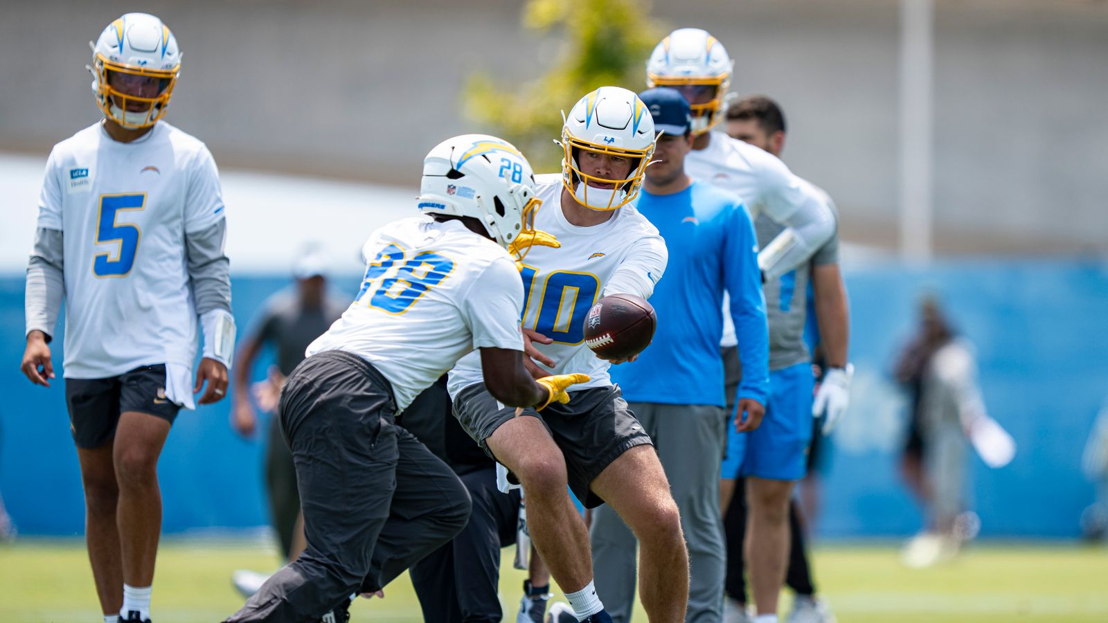 Justin Herbert hands off to Kimani Vidal at Chargers OTA