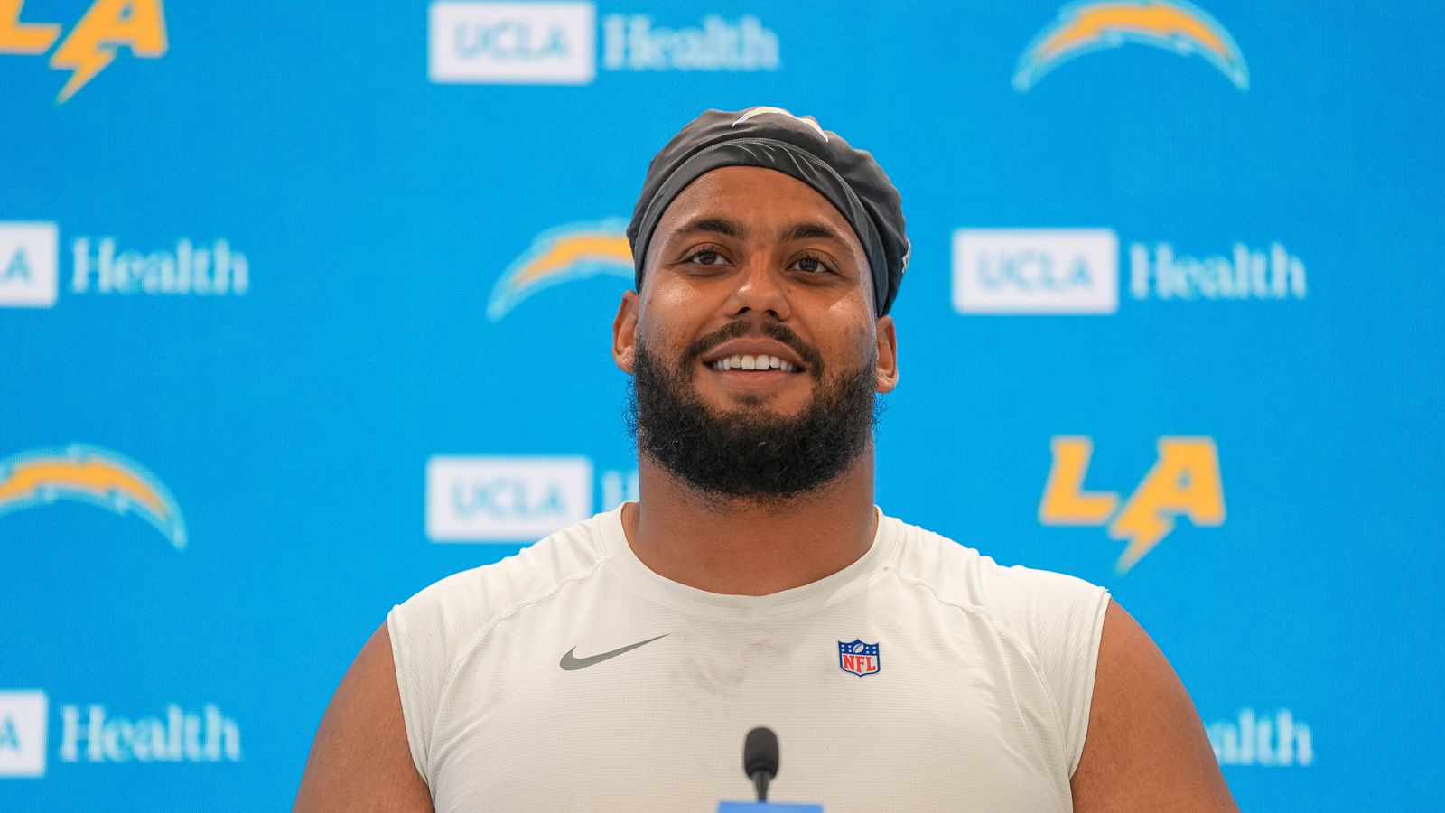 Rashawn Slater talks to the press at Chargers OTA