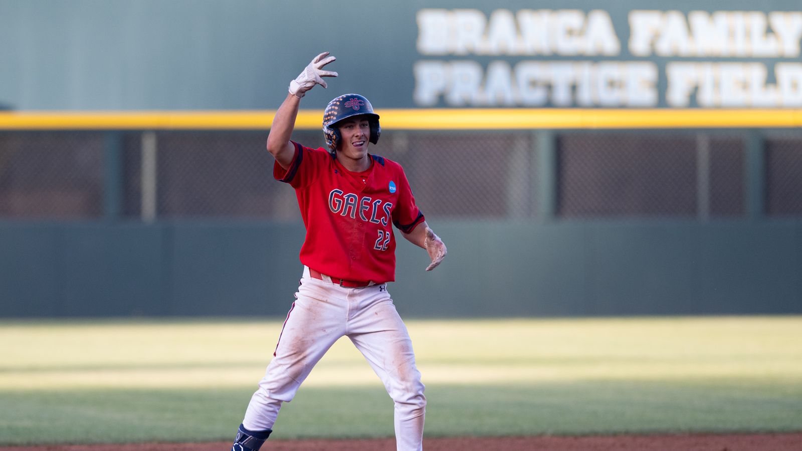 Tanner Griffith gestures after reaching second base