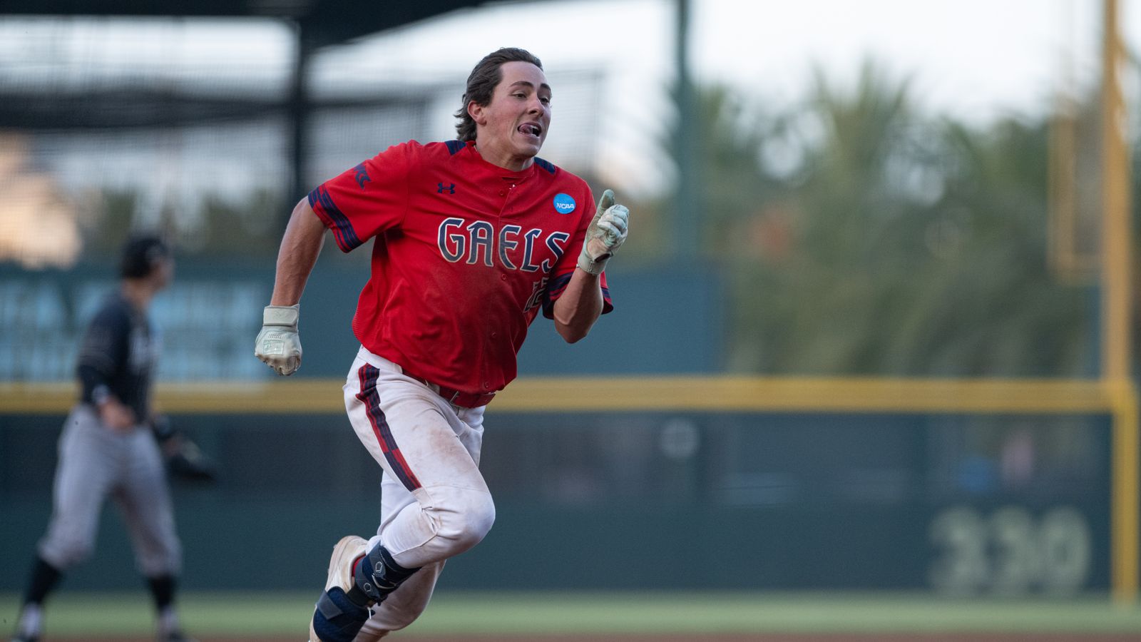 Tanner Griffith runs to third base in NCAA regional game