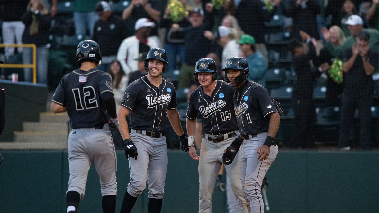 Cal Poly celebrates a 3 run inning in NCAA regional game