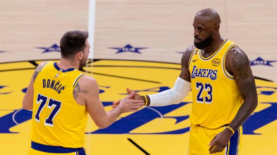 LeBron James and Luka Doncic high five during a game, January 15, 2026, LA.