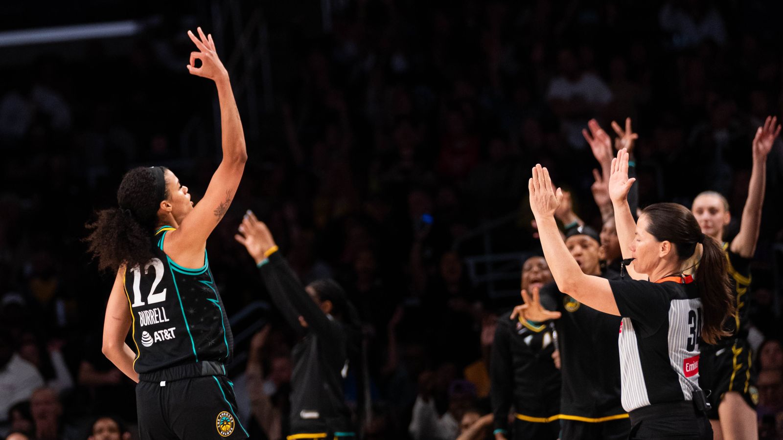 Rae Burrel (12) celebrates a three-pointer against the Aces.