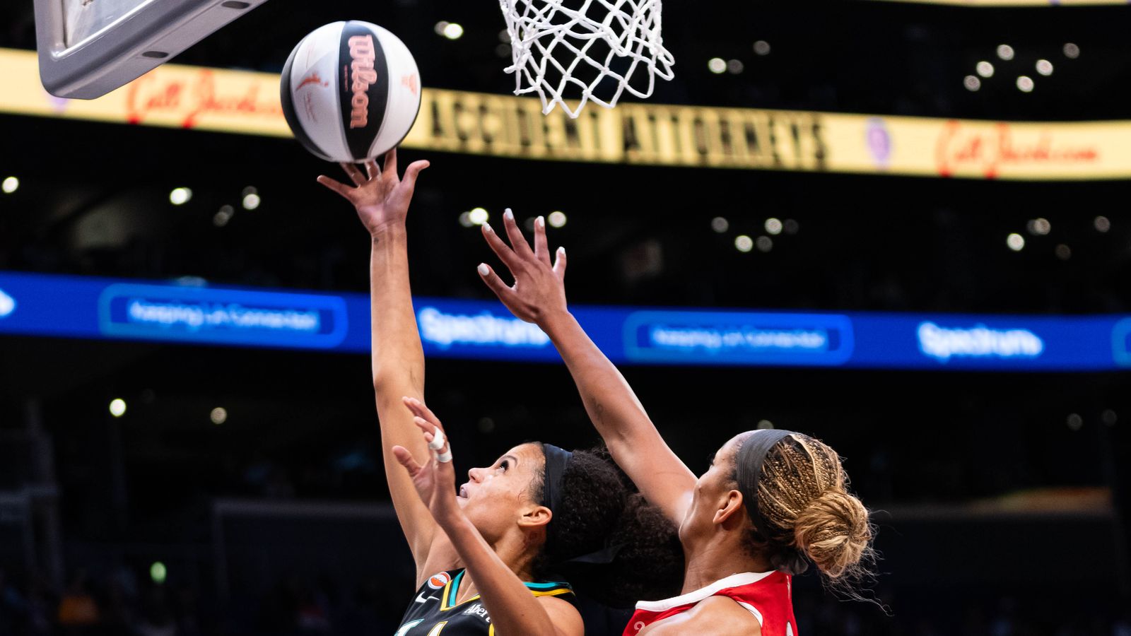 Rae Burrel (12) makes a drive towards the basket against the Aces.