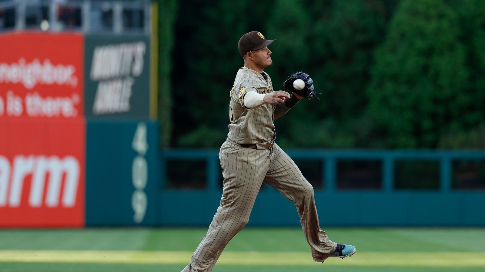 Manny Machado throws to first in game against Phillies
