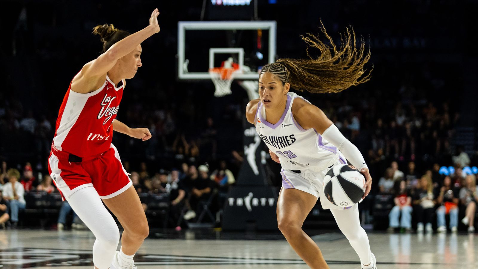 Veronica Burton dribbles towards the basket in a WNBA game
