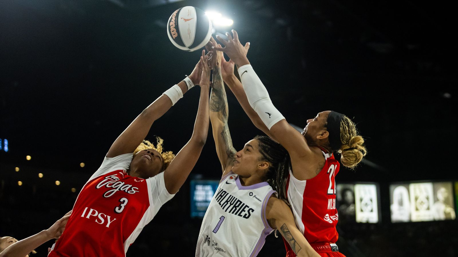 Smith and Wilson jump for a rebound in WNBA action