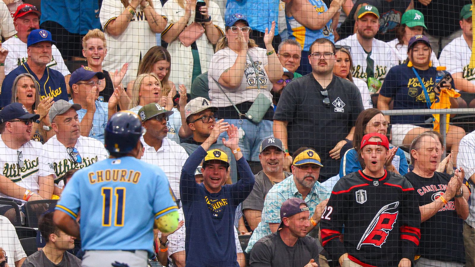 Brewers fans cheer as Jackson Chourio scores a run.