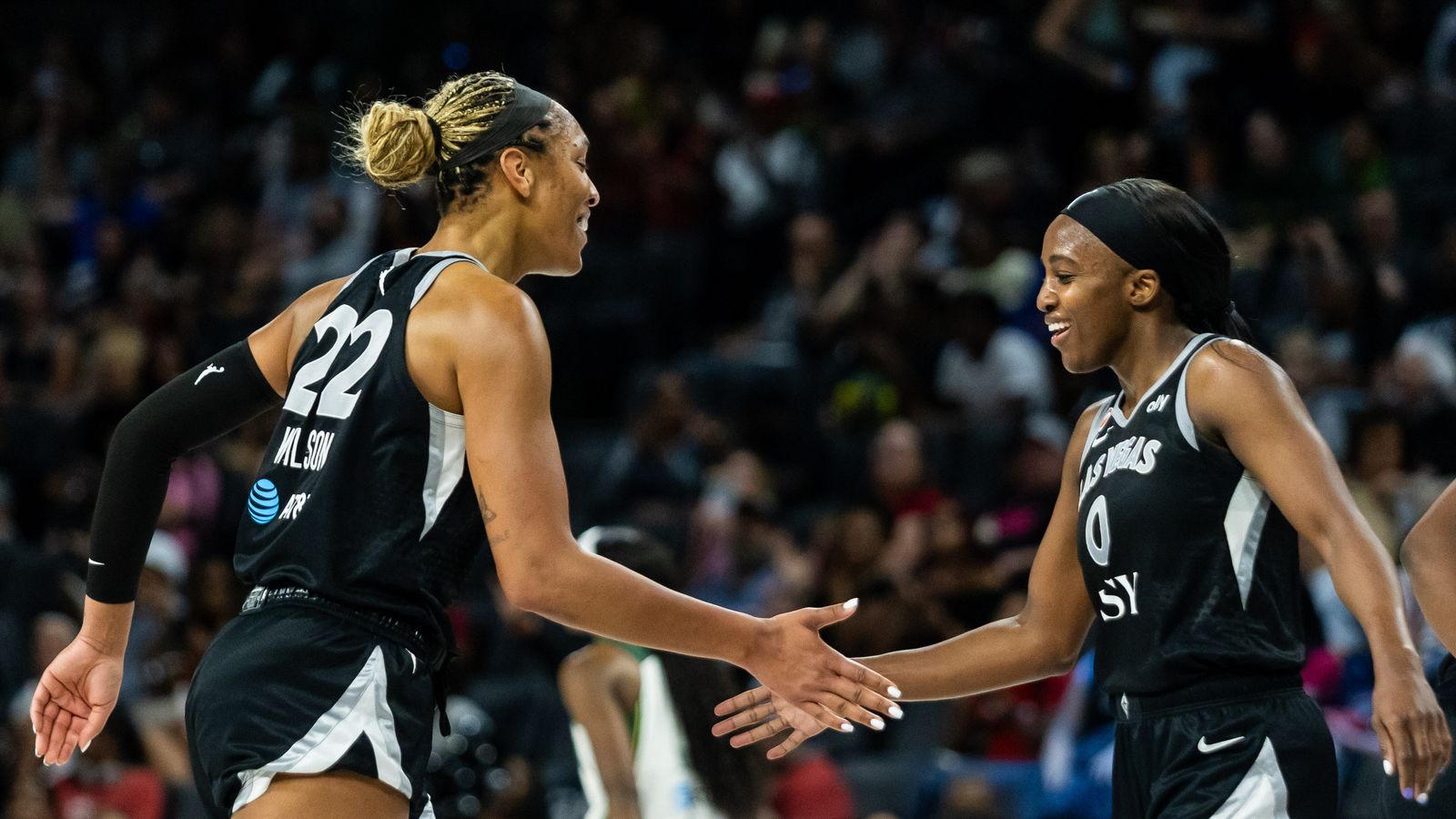 Wilson and Young high-five in WNBA game, Las Vegas vs. Seattle