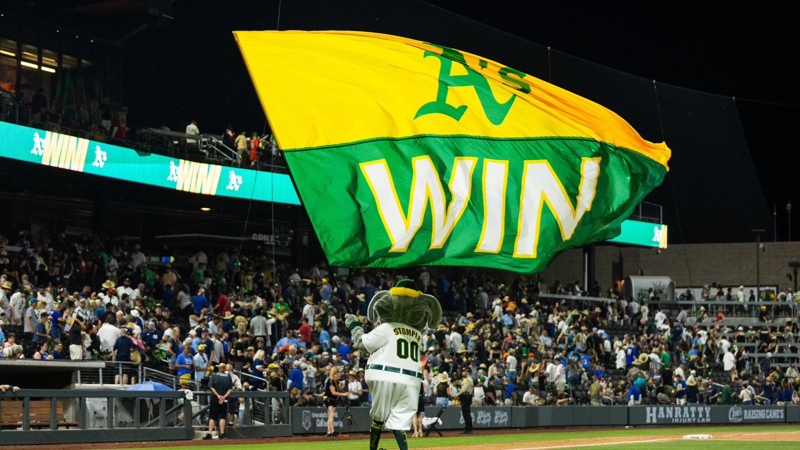 Athletics' mascot celebrates victory with a flag at Las Vegas Ballpark
