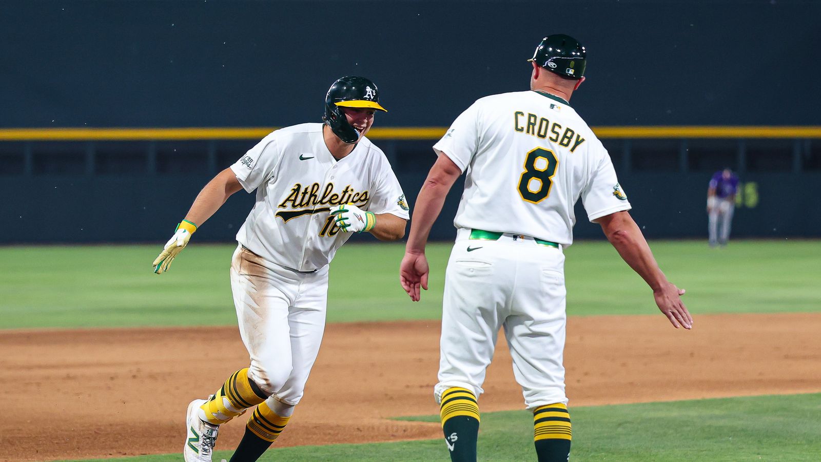 Nick Kurtz high-fives coach Crosby after home run against Rockies