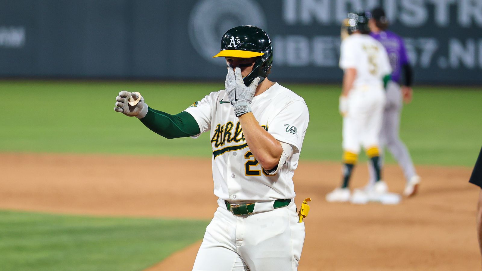 Zack Gelof points to dugout after hitting a single against Rockies