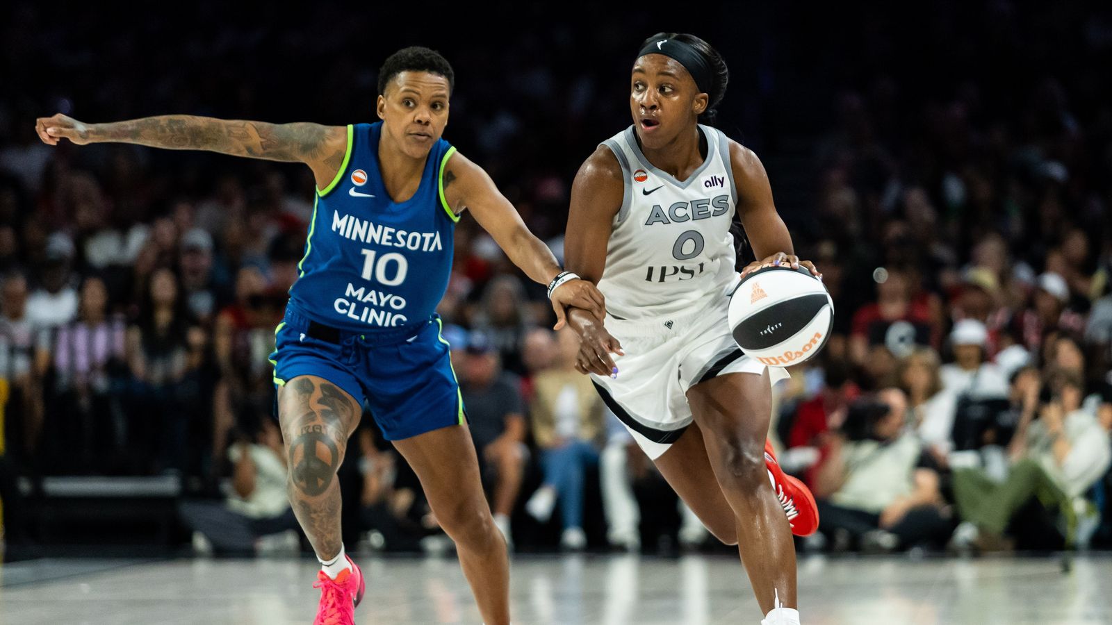Jackie Young maneuvers past Courtney Williams in Las Vegas