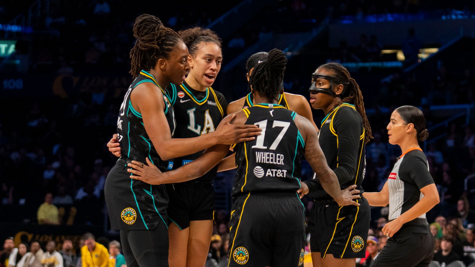 Sparks huddle during a timeout against the Lynx at Crypto.com Arena