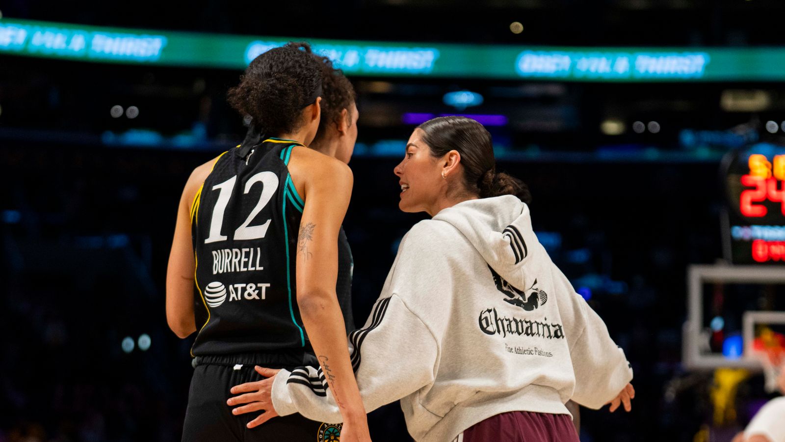 Kelsey Plum coaches the Sparks during a game against the Lynx