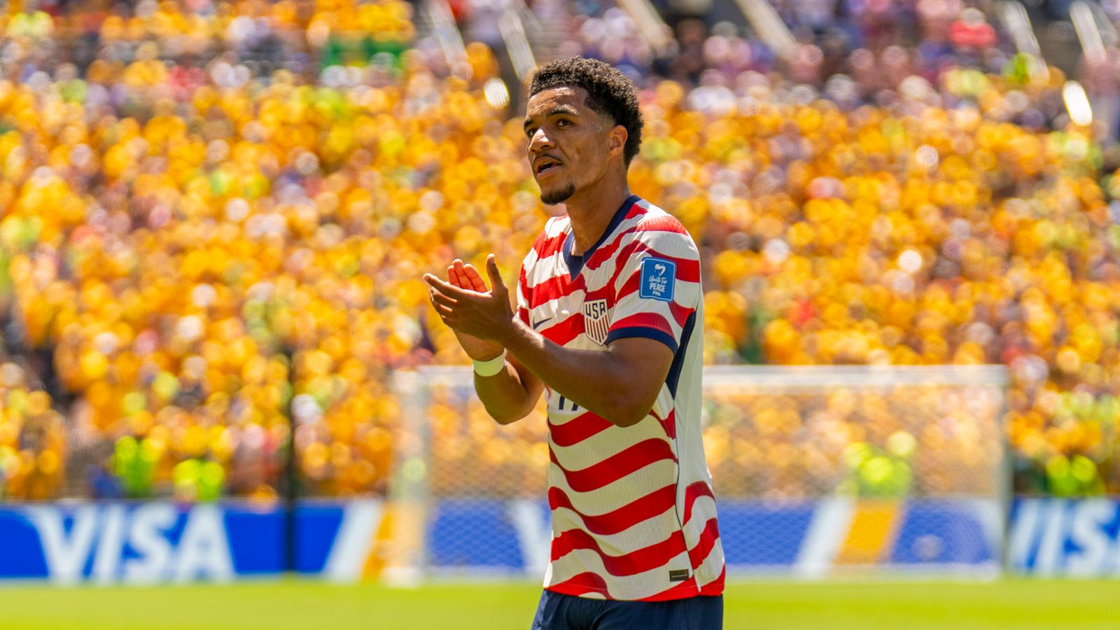 Malik Tillman cheers the crowd in the World Cup match against Australia.
