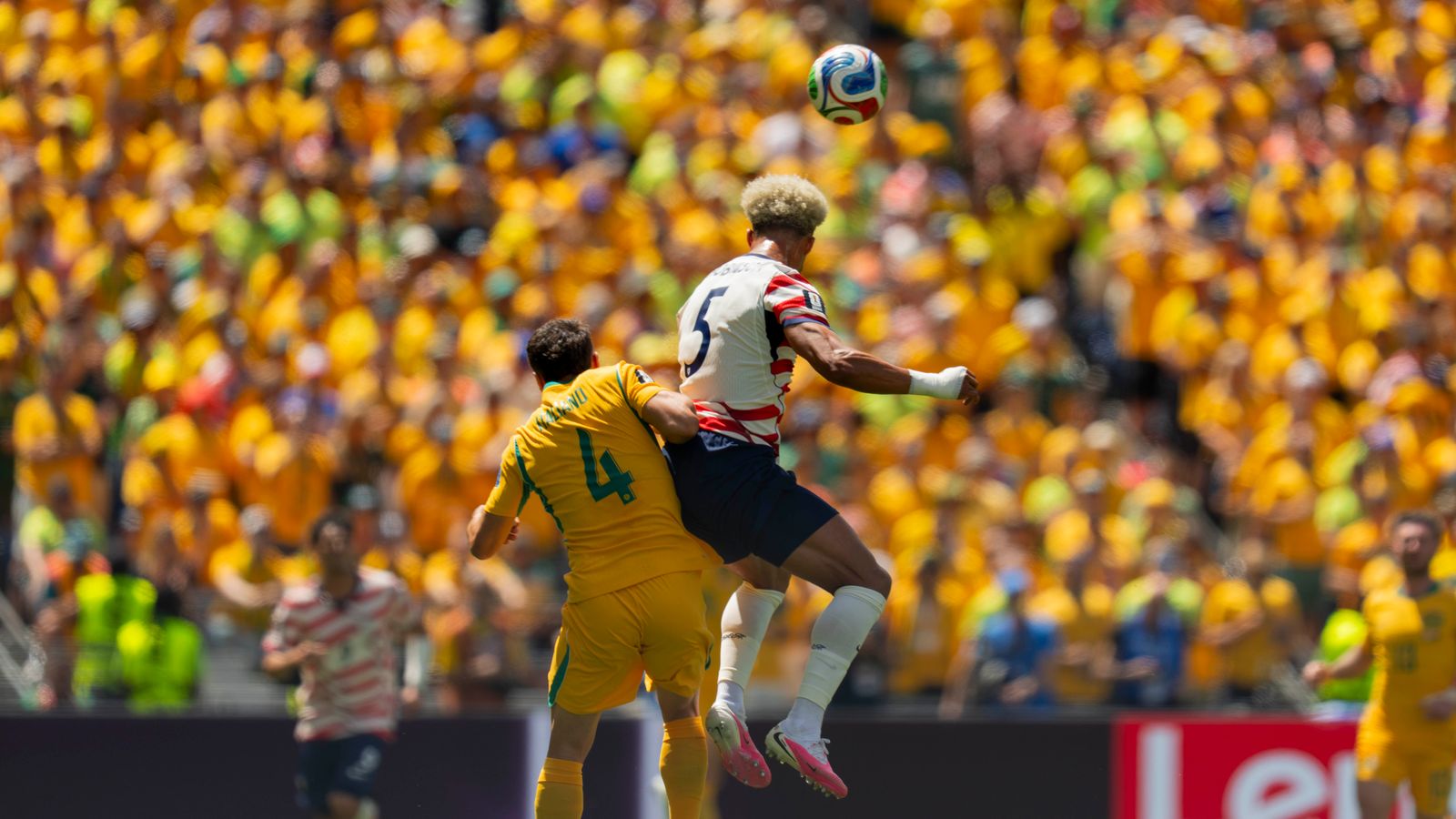 Antonee Robinson wins a header in the World Cup match against Australia.