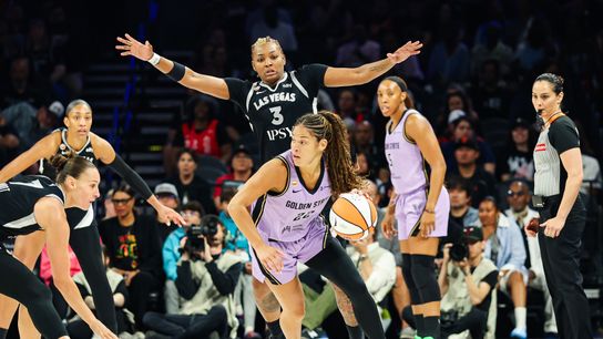 Veronica Burton passes under pressure from Nalyssa Smith.