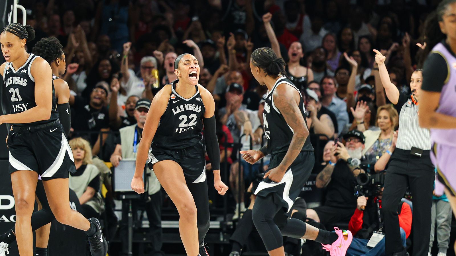 A'ja Wilson celebrates scoring for the Aces against the Valkyries.