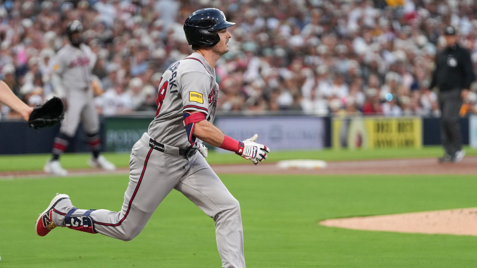 Mike Yastrzemski hustles to first base in San Diego