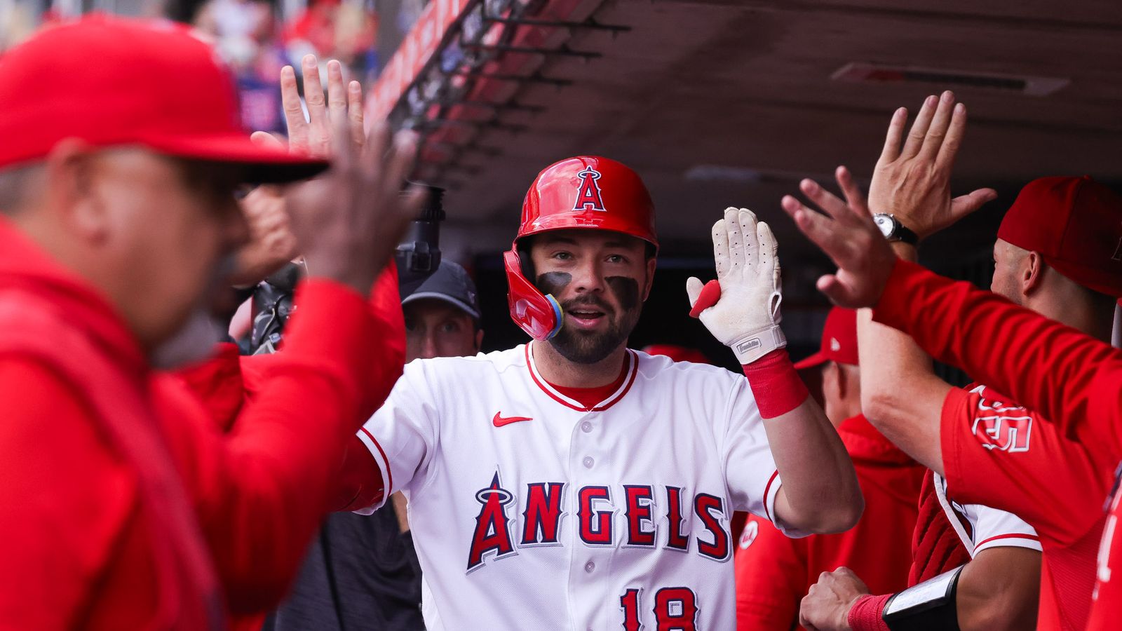 Nolan Schanuel celebrates a home run in the dugout