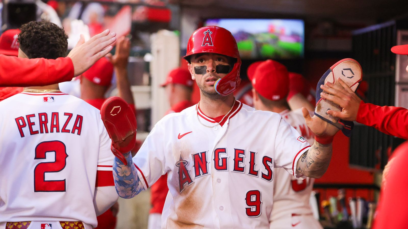 Zach Neto celebrates after scoring against the Orioles