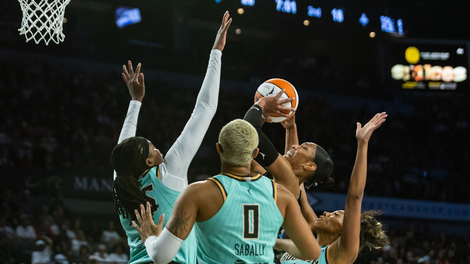 A'ja Wilson shoots surrounded by Liberty players in WNBA clash.
