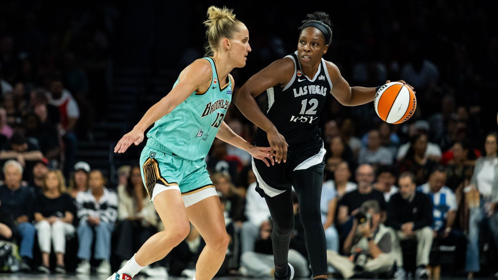 Chelsea Gray advances the ball with Leonie Fiebich in pursuit.