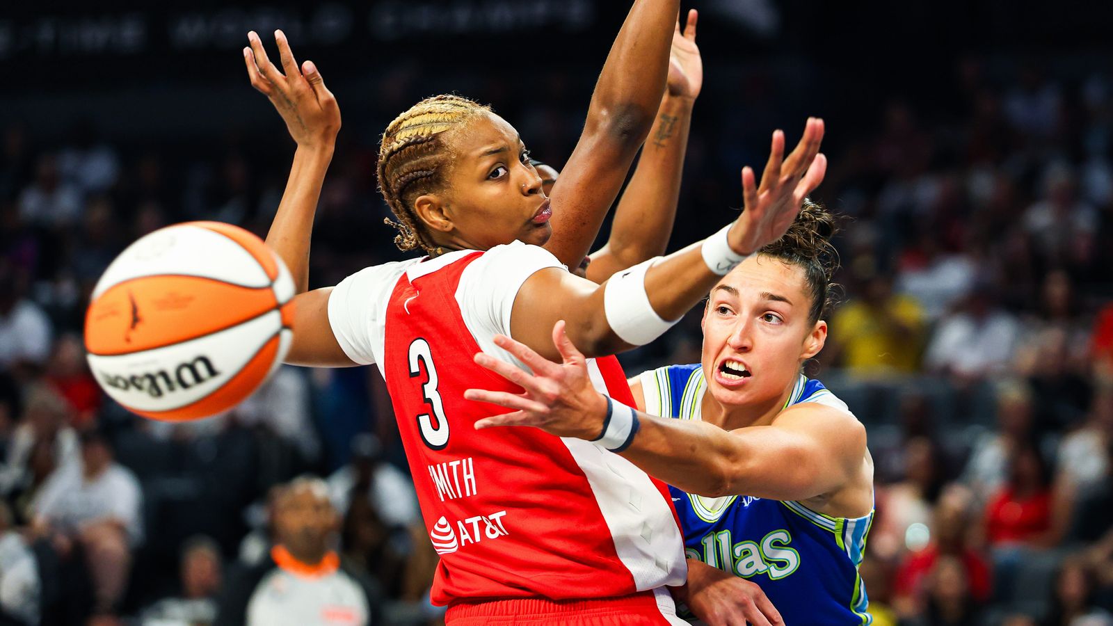 Jessica Shepard maneuvers around Nalyssa Smith in a tense WNBA clash.