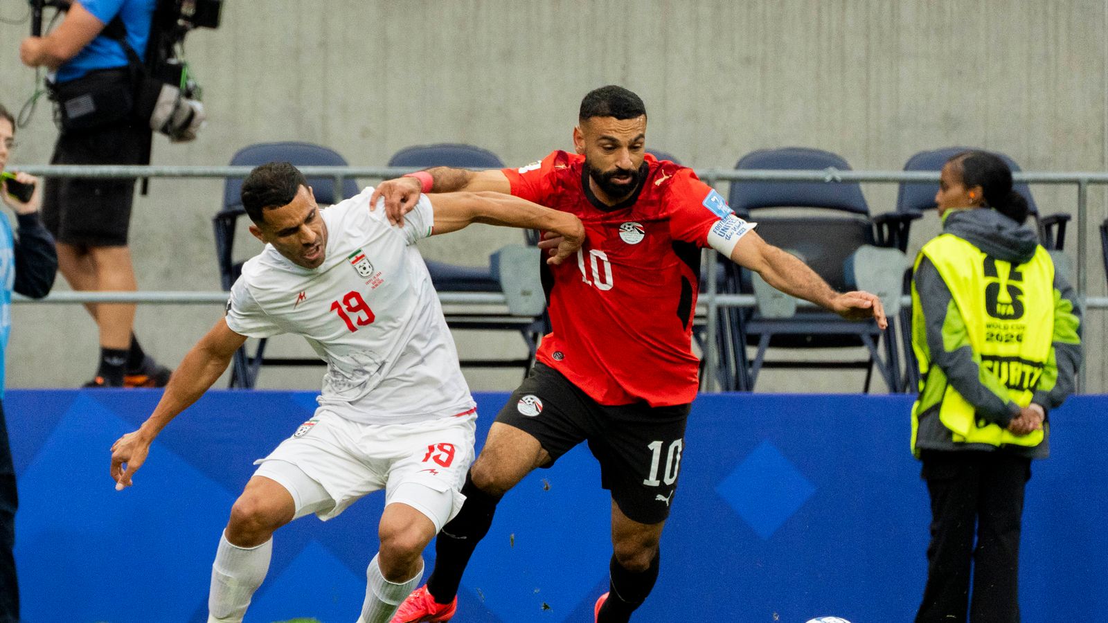 Mohamed Salah and Ali Nemati vie for the ball in World Cup match