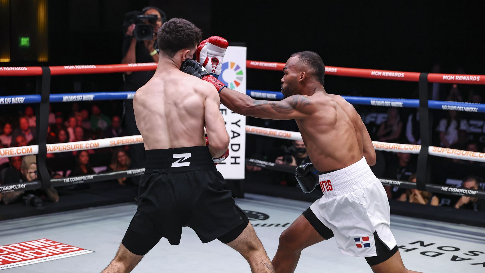 Edwin De Los Santos lands a left during the exchange.