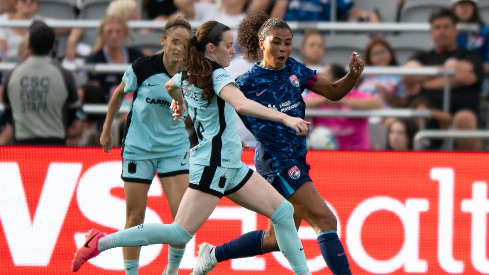Kennedy Wesley pressures Rose Lavelle in a tight defensive play