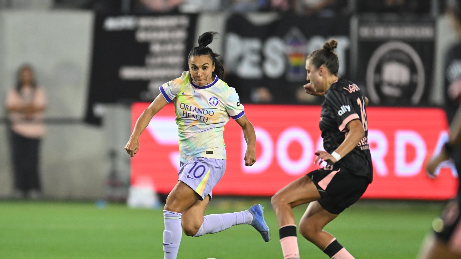 Marta advances with the ball under pressure