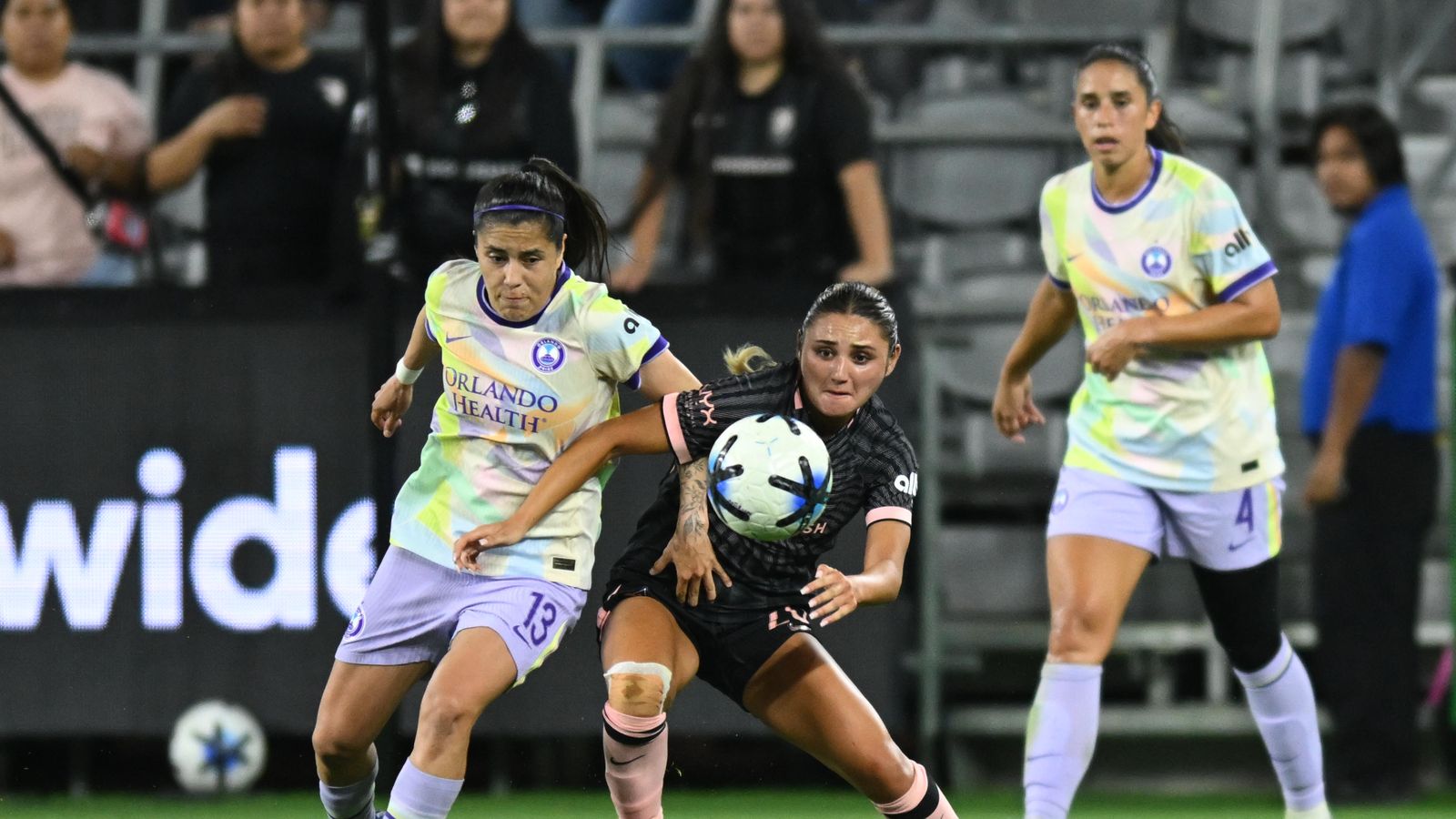 Gisele Thompson battles for possession in midfield