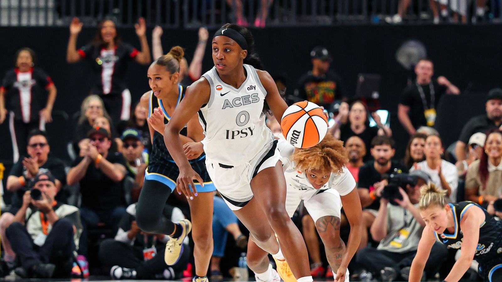 Jackie Young drives up the court in a WNBA game.