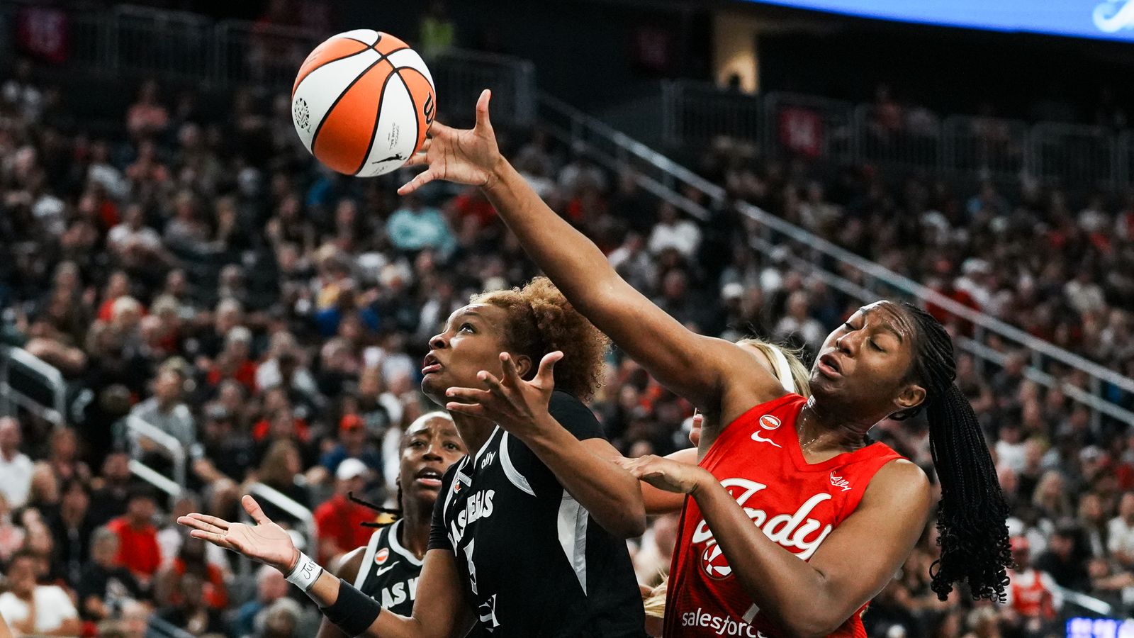 Aliyah Boston goes for a rebound against Nalyssa Smith