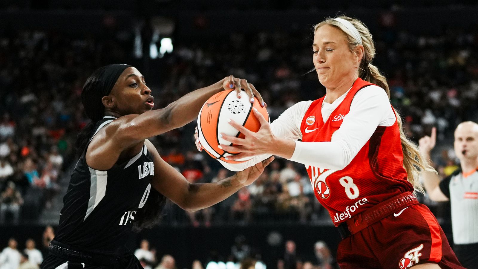Sophie Cunningham holds the ball tightly against Jackie Young