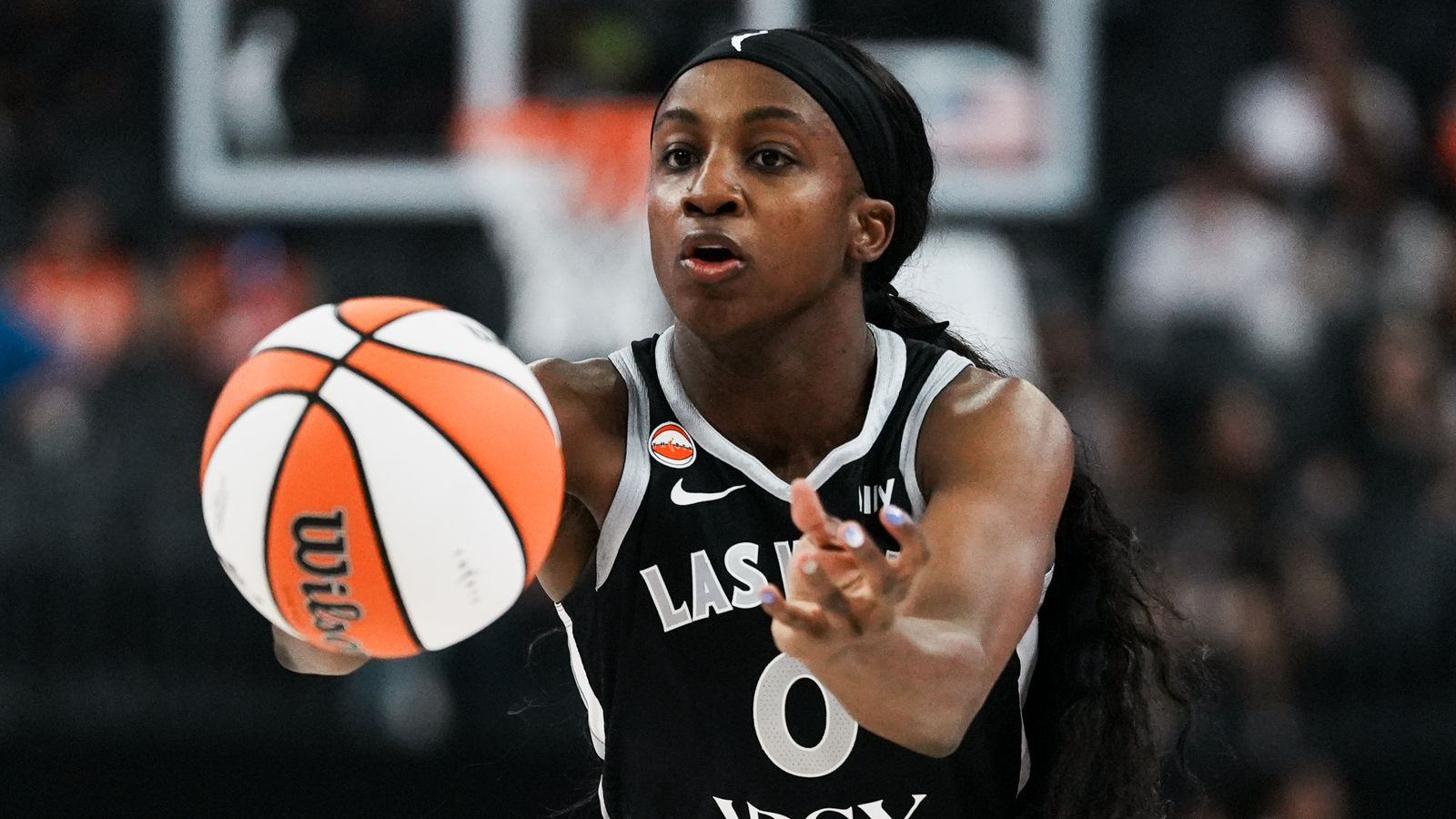 Jackie Young passes the ball during a WNBA game against the Fever