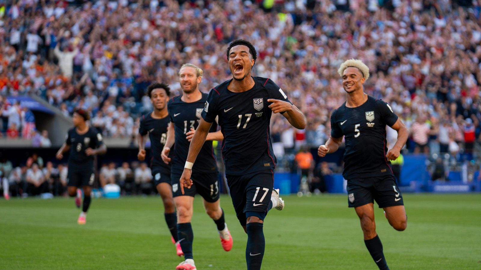 Malik Tillman celebrates his goal in the World Cup match against Belgium.