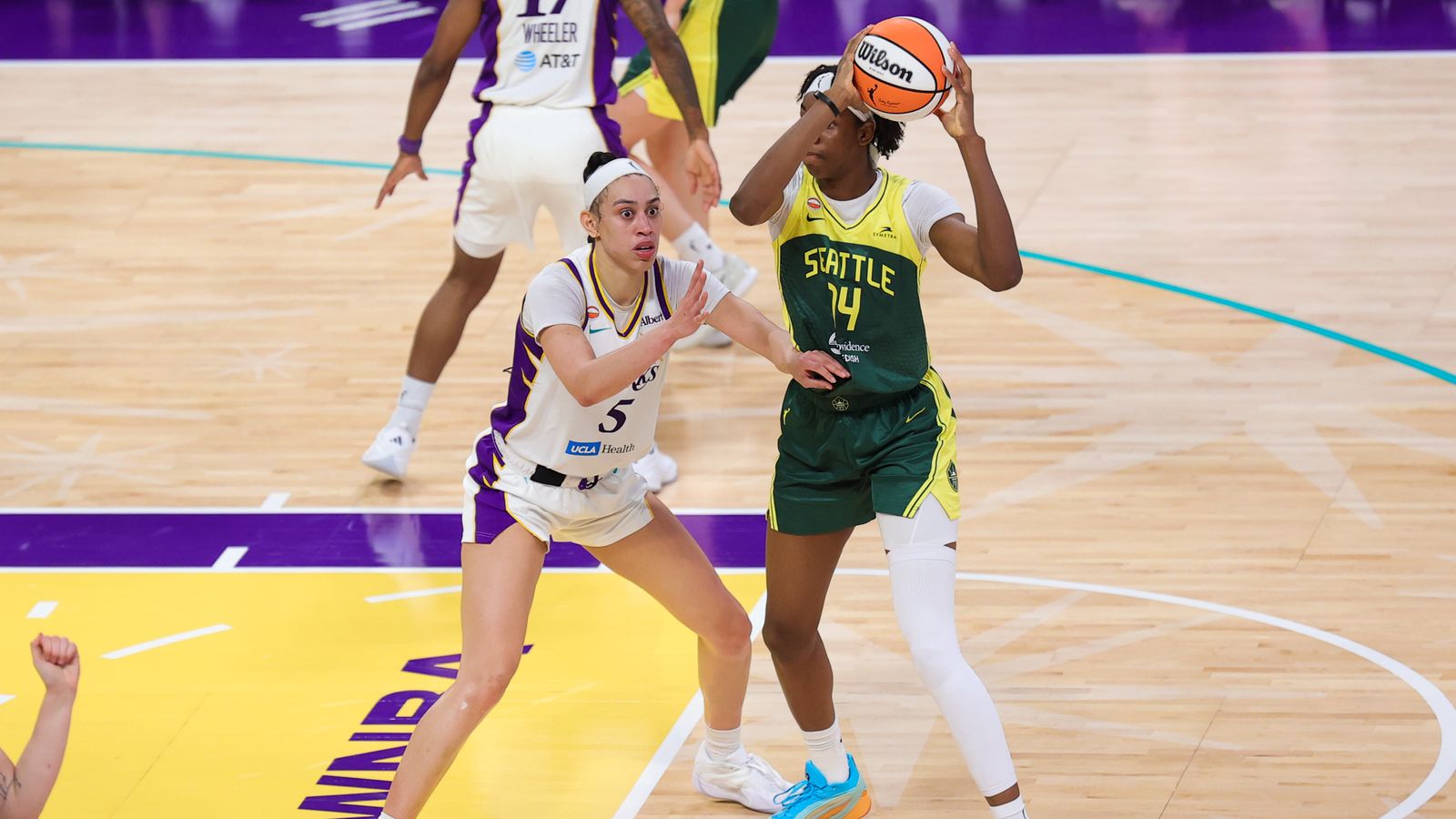 Dearica Hamby defends against Dominique Malonga in WNBA game.