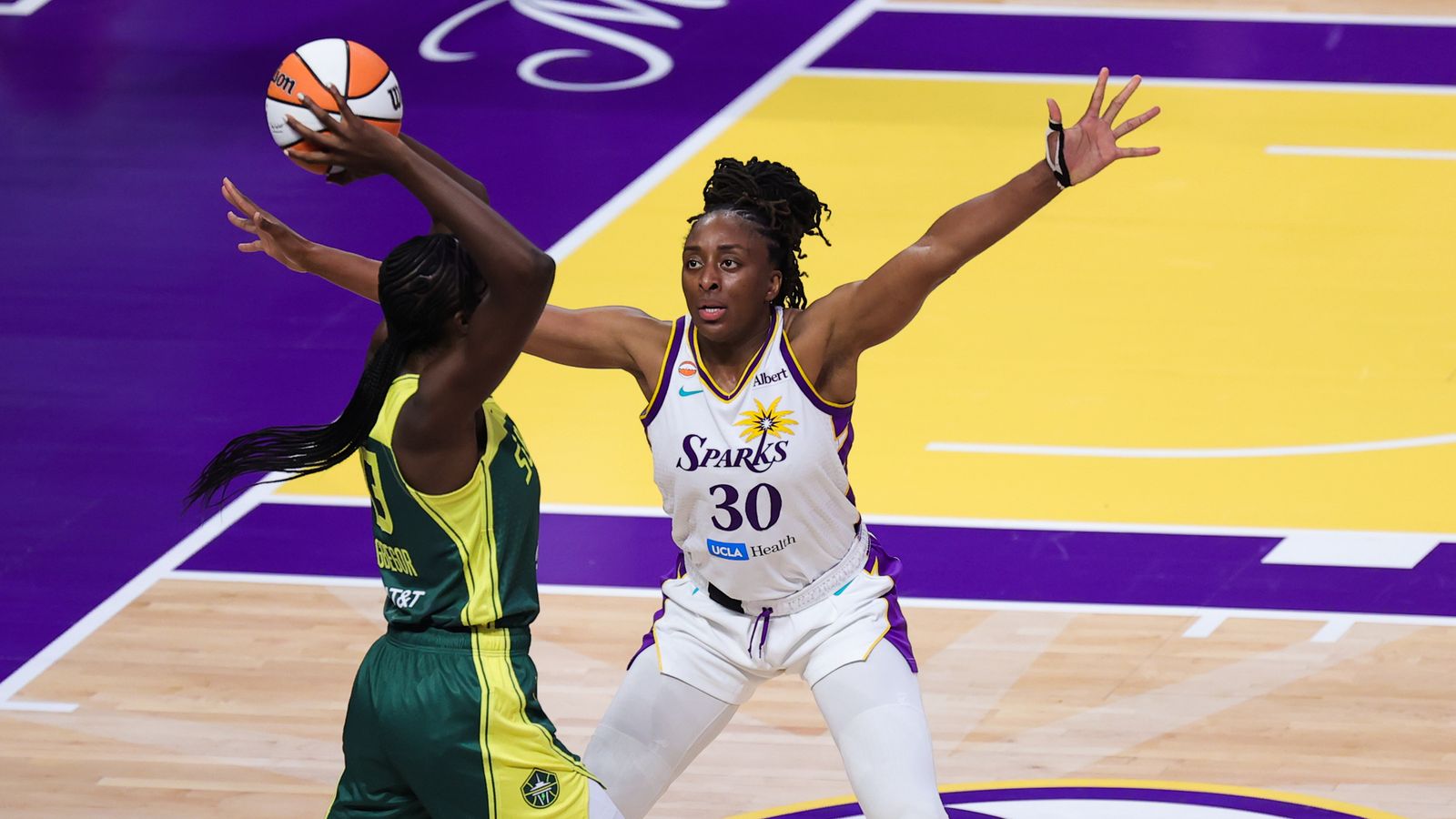 Nneka Ogwumike defends against Ezi Magbegor in WNBA game.