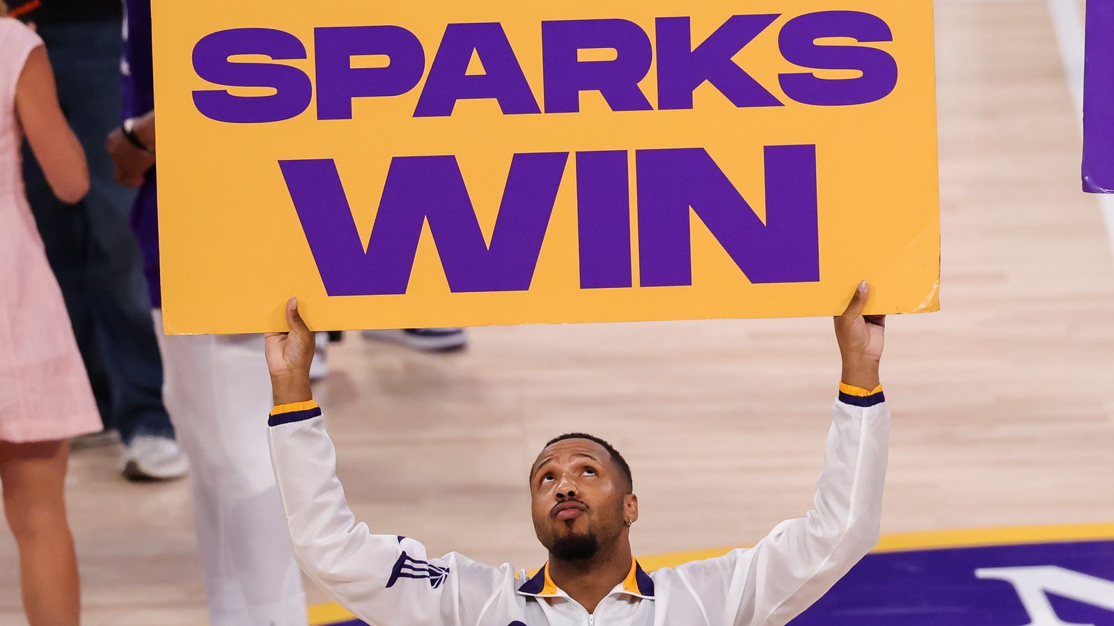Sparks Crew celebrates with 'Sparks Win' sign after the game
