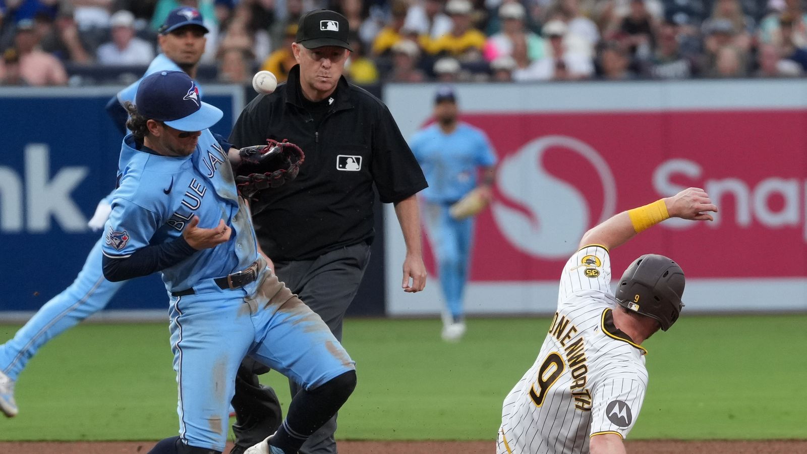 Jake Cronenworth slides into second base against Blue Jays